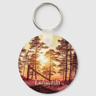 Sunset over wooden path in pine forest key ring