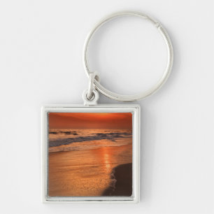 Sunset reflections off clouds and ocean shore key ring