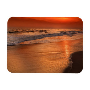 Sunset reflections off clouds and ocean shore magnet