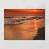 Sunset reflections off clouds and ocean shore