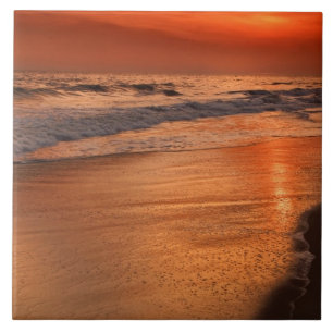 Sunset reflections off clouds and ocean shore tile