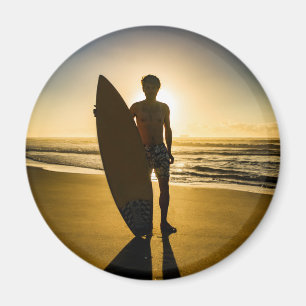 Surfer silhouette during sunrise magnet