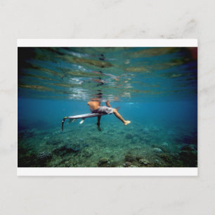 Surfer sitting on surfboard over coral reef postcard