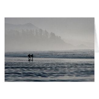 Surfers in the mist.
