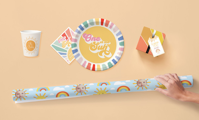 An assortment of colorful party supplies with the theme "One in the Sun"