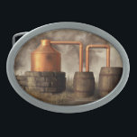 Swamp Moonshine Still Belt Buckle<br><div class="desc">A copper pot still churns away in a misty swamp. Dark smoke billows from the furnace while moonshine trickles into a jug from the worm. It looks like the moonshiner has run off though. Once should never leave a still alone when distilling. Actually, this would not be a particularly practical...</div>