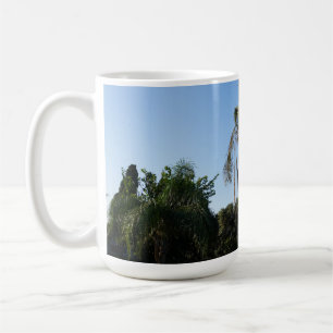 Swaying Palm Tree Under a Clear Sky Coffee Mug