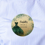 Sweet 16 emerald green gold dress 6 cm round badge<br><div class="desc">For an elegant Sweet 16,  16th birthday.  A faux gold looking background. Decorated with an emerald green dress and green confetti. Personalise and add a name and a date.</div>