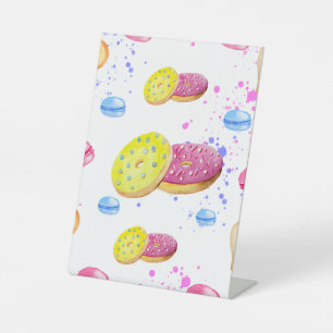 Sweet doughnuts with colourful glaze pattern pedestal sign