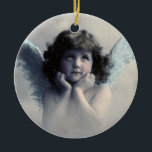 Sweet Vintage Angel Christmas Ceramic Tree Decoration<br><div class="desc">Beautiful vintage design of a sweet Christmas angel with soft white wings and rosy cheeks, holding her face in her hands. Looking peaceful and kind. The background is filled with soft ethereal clouds. The back has a faded vintage texture with text that says Christmas 2014 and you can customise /...</div>