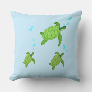 Swimming green sea turtles on turquoise cushion