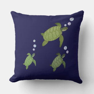 Swimming sea turtles on navy blue cushion