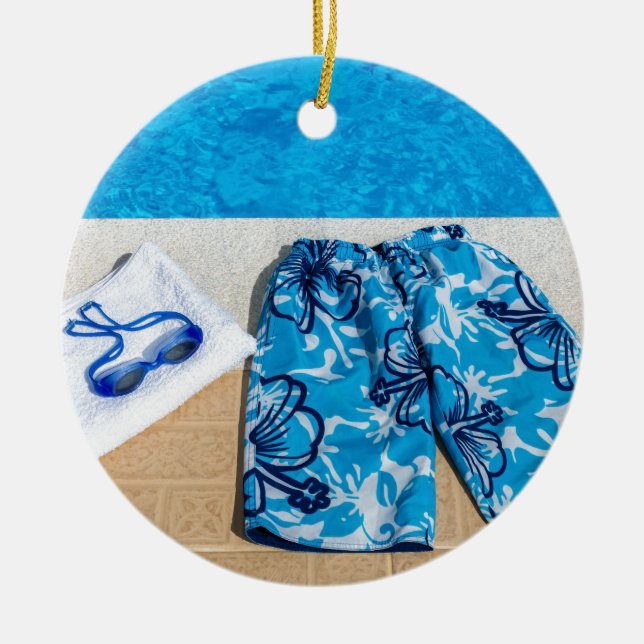 Swimming trunks goggles and towel at pool ceramic tree decoration (Front)
