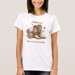 T-Shirt<br><div class="desc">Add a rustic charm to your wardrobe with this unique cowboy floral t-shirt. Featuring classic cowboy boots adorned with delicate boho-style flowers in earthy tones, this t-shirt captures the spirit of the Wild West with a modern, artistic twist. Perfect for personalising with your special girl's name, this tee makes an...</div>
