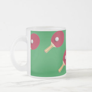 Table tennis racket and ball on green frosted glass coffee mug