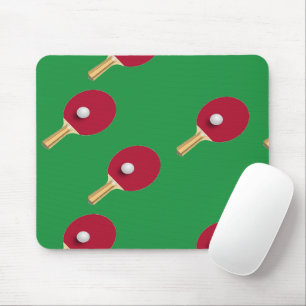 Table tennis racket and ball on green mouse mat
