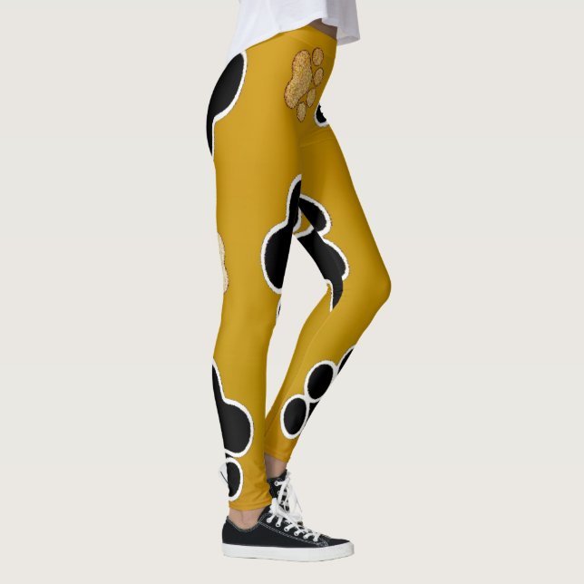 Tan and black paw print on a gold background #2 leggings (Right)