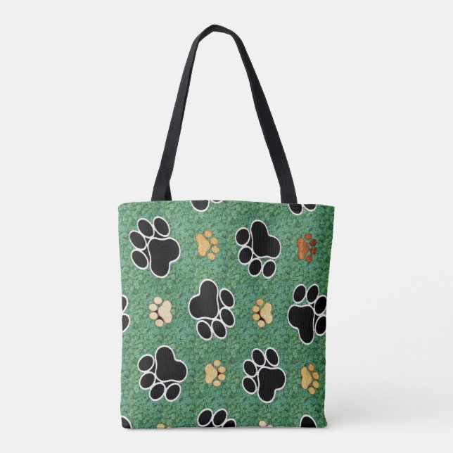 Tan and black paw print on green grass tote bag (Back)