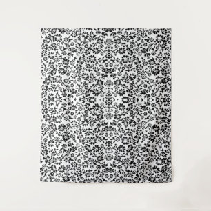 Tapestry blanket with a black and white flowers.