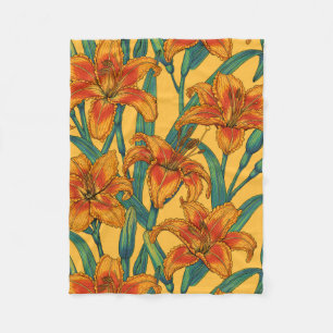 Tawny daylily flowers, blue and yellow fleece blanket