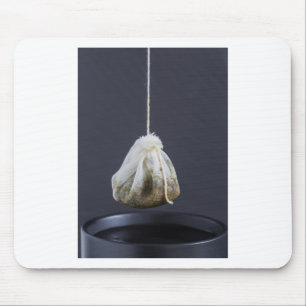 Tea bag is hung in a cup mouse mat