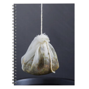 Tea bag is hung in a cup notebook