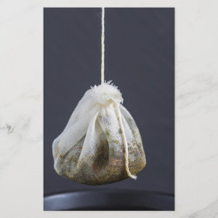 Tea bag is hung in a cup stationery