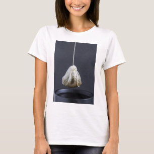 Tea bag is hung in a cup T-Shirt