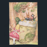 Tea Party 4 Towel<br><div class="desc">16” x 24” kitchen towel with a vintage Alice in Wonderland image of Alice peering from behind a tree at a Mad Hatter's tea party in progress with the Mad Hatter, March Hare, and Dormouse, by artist A. H. Watson (1939). See the entire Wonderland Kitchen Towel collection in the FOOD/BEV...</div>