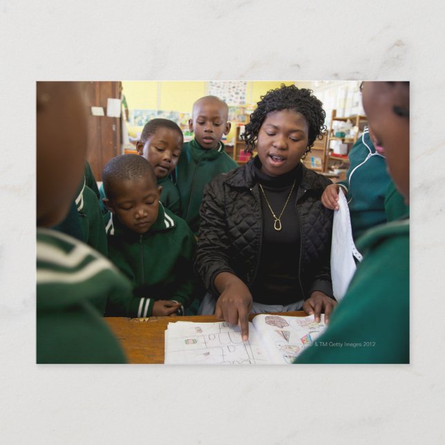 Teacher assists a group of learner's in the postcard (Front)