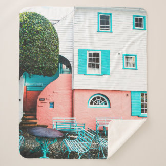 TEAL AND GRAY TABLE AND BENCH BESIDE WHITE AND ORA SHERPA BLANKET