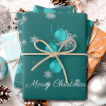 Teal Christmas Ornaments Wrapping Paper Sheets<br><div class="desc">Wrap gifts for under the Christmas tree this holiday season with Teal Christmas Ornaments Wrapping Paper.  Wrapping paper design features a trio of hanging Christmas ornaments with falling snowflakes and a dark teal background. Additional gift and holiday items available with this design as well.</div>