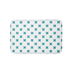 Teal cross stitches on white bath mat