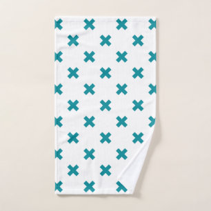 Teal cross stitches on white hand towel