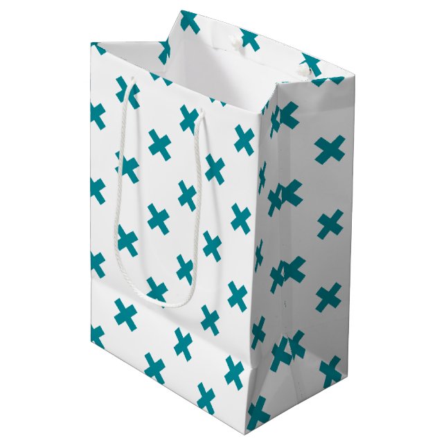 Teal cross stitches on white medium gift bag (Front Angled)