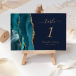 Teal Gold Agate Navy Blue Wedding Table Number<br><div class="desc">The left-hand edge of this elegant modern wedding table number card features a teal blue watercolor agate border trimmed with faux gold glitter. The customisable text combines gold-coloured handwriting,  italic and copperplate fonts on a navy blue background.</div>