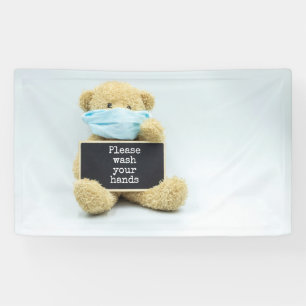 Teddy bear wear face mask with please wash hands banner