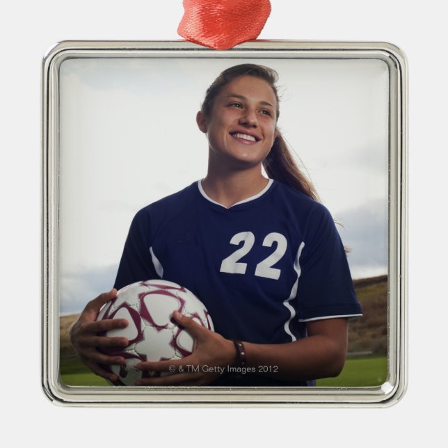 teen girl soccer player holding soccer ball metal tree decoration (Front)