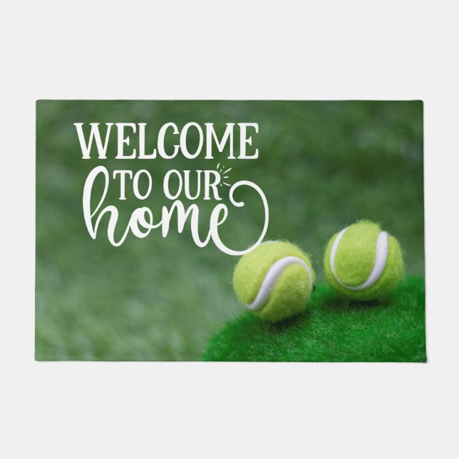 Tennis ball are on green grass welcome doormat (Front)