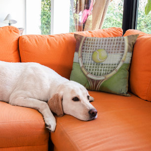 Tennis Racket with Ball Laying on Court Cushion