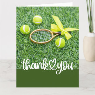 Tennis with racket and balls on green grass thank you card