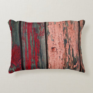Texture of old wooden fence painted in red and ora decorative cushion