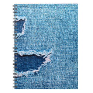 Textured denim background. Torn hole in the fabric Notebook
