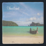 Thailand Travel Beach Photo with Fishing Boat Stone Coaster<br><div class="desc">An exotic travel destination. Thailand in South East Asia. This travel photo features a pretty scenic tropical beach from Thailand. Crystal clear turquoise waters, soft sandy beach, bright blue sky and lush green trees in the background. A single fishing boat sits on the beach ready to go fishing for the...</div>