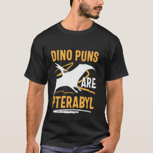 That says Dino Puns Are Pterribyl - Funny Dinosaur T-Shirt