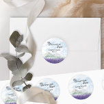 The Adventure Begins Lavender Valley Wedding Classic Round Sticker<br><div class="desc">The Adventure Begins, personalised wedding stickers, perfect for a mountain wedding resort or destination wedding in scenic countryside. The design features modern typography and an idyllic watercolor landscape. The dreamy mountain ridge scene depicts mountains, green hills and a peaceful country valley meadow with swathes of lavender, purple wildflowers or highland...</div>