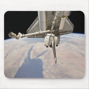 The aft section of the docked space shuttle mouse mat