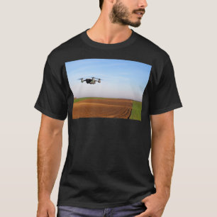 The drone is flying over the plowed field 1 T-Shirt