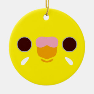 The face of a lutino budgie ceramic tree decoration