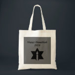 The Flame & Star - Tote Bag<br><div class="desc">This image is a flame from a candle. A star around the flame represents Hanukkah. Done in a black tattoo. A black backround was also added. "Happy Hanukkah 2014" is printed on this design. Customise with your own words. These totes are available in assorted styles,  colours and sizes.</div>